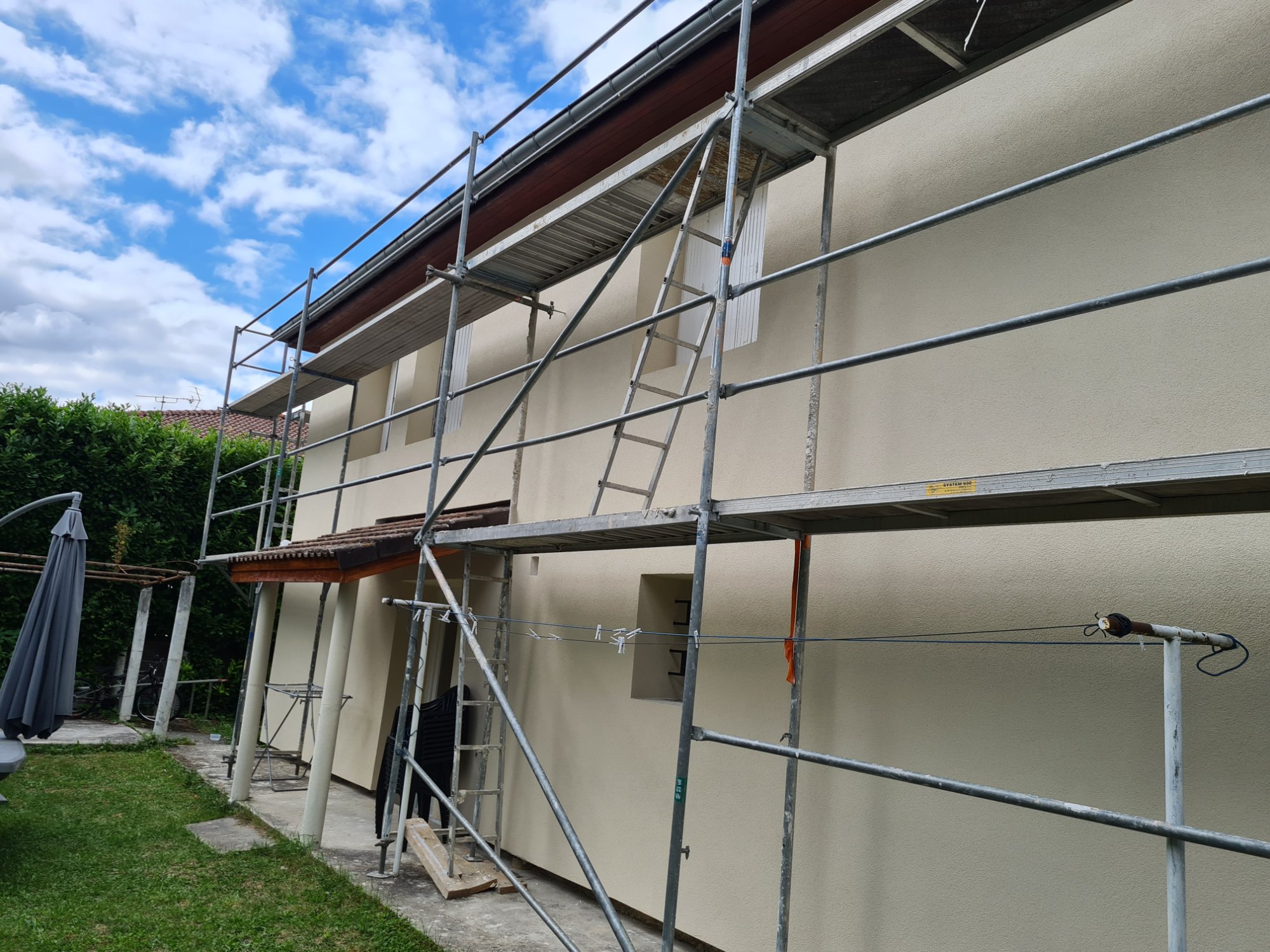 Chantier isolation extérieure ITE été façade maison Lyon échafaudage pose panneaux polystyrène graphite entreprise RGE MG1 Bati Concept rénovation thermique ravalement enduit Rhône 69