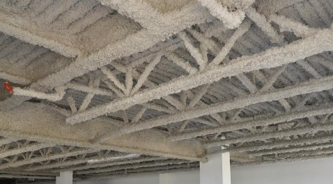 Flocage coupe-feu poutre métallique structure acier protection incendie REI projection laine minérale Lyon immeuble bâtiment industriel ERP entreprise certifiée RGE Qualibat syndic